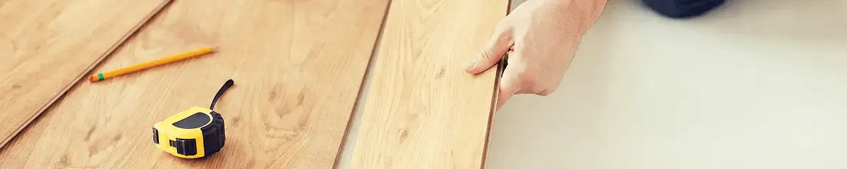 A professional installing wood flooring in Kansas City, MO