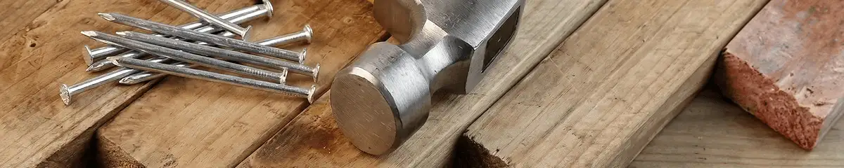 Hammer and nails on hardwood flooring boards in Kansas City, MO