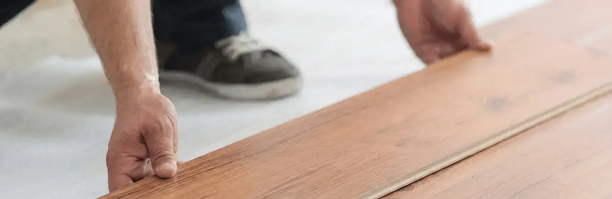 A professional installing laminate flooring in Kansas City, MO