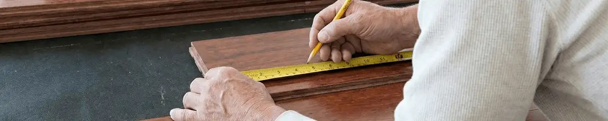 A professional installing wood flooring in Kansas City, MO